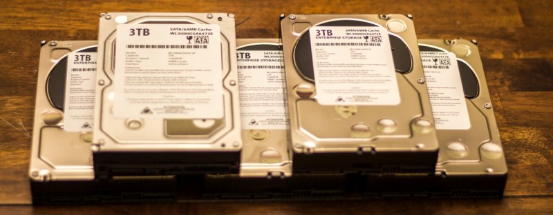 A bunch of white-label hard drives on a table